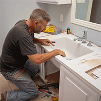 plumber inspecting a bathroom sink