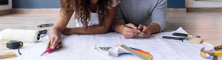 couple looking at house blueprints