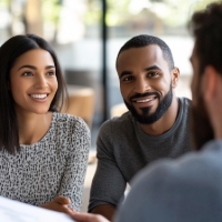 a couple speaking to a man