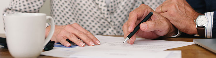 midsection of a couple going through some paperwork