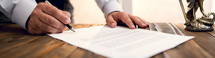 man signing legal document