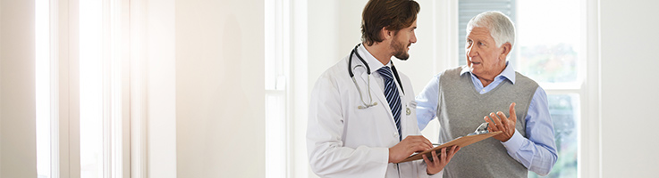 older man talking to a doctor