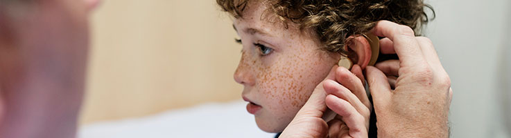 young boy at hearing aid appointment