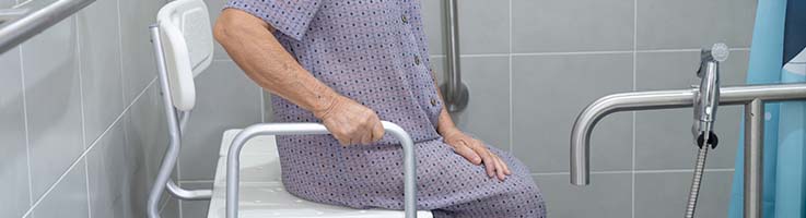 elderly woman using shower chair