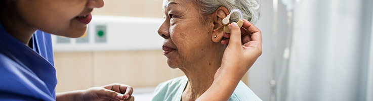 elderly woman with hearing aid