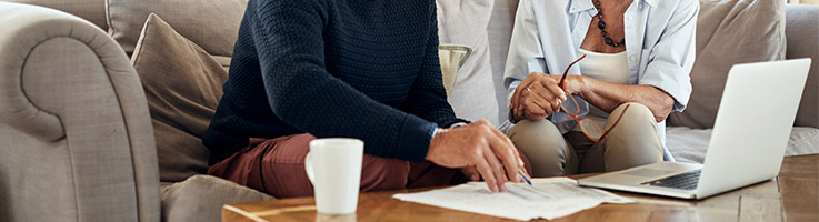 older couple sitting and going over financial documents