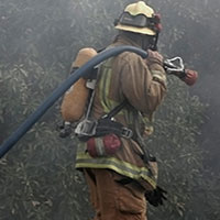 fireman walking with hose