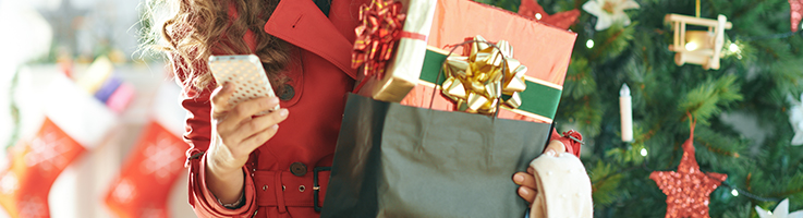 woman holding shopping bags with christmas presents