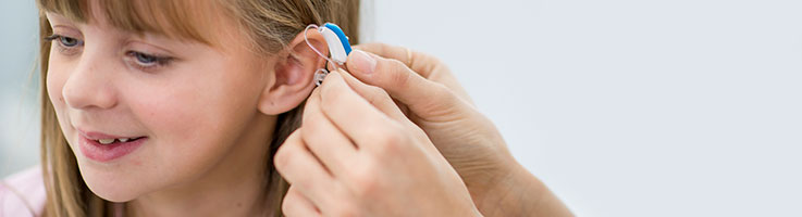young girl getting new hearing aids