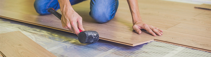 man laying hardwood floor