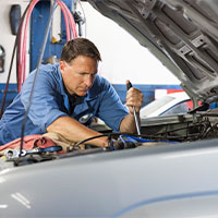 auto mechanic checking car engine