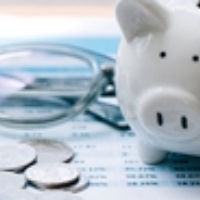 calculator with piggy bank, coins, and paperwork