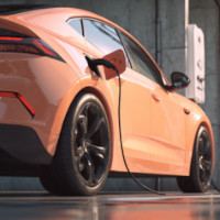 coral-colored electric car recharging