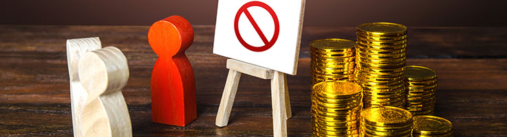 presentation with a prohibition sign in between stacks of gold coins and miniature wooden blocks representing a speaker presenting to an audience