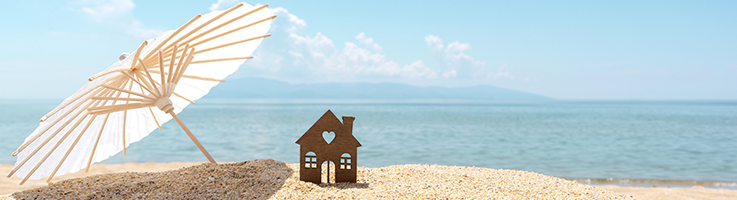 umbrella and miniature house on the beach