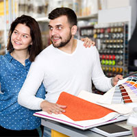 couple choosing a color scheme in a paint store
