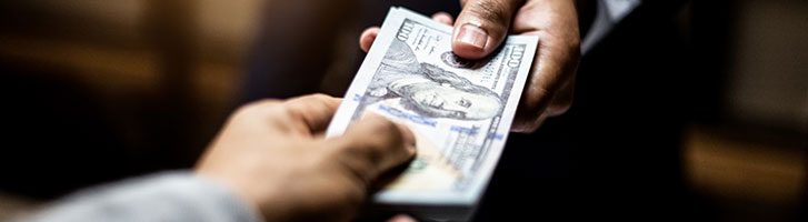 man giving money to another man