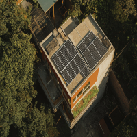 aerial view of a building with solar panels on the roof