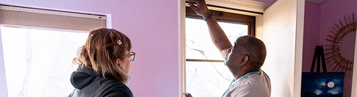 woman having a security system door sensor installed