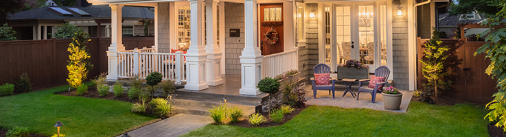 front yard with lighting and nice lawn