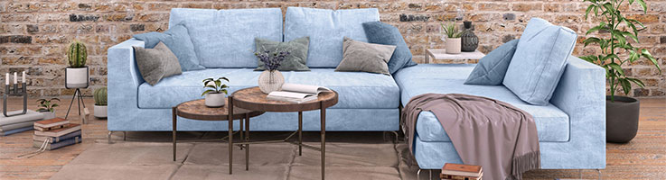 blue couch in an exposed brick living room