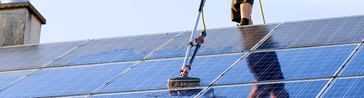 man cleaning solar panels