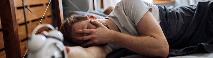man waking up with hangover