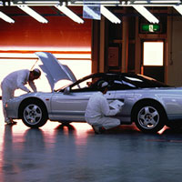 workers carrying out quality inspection on a car
