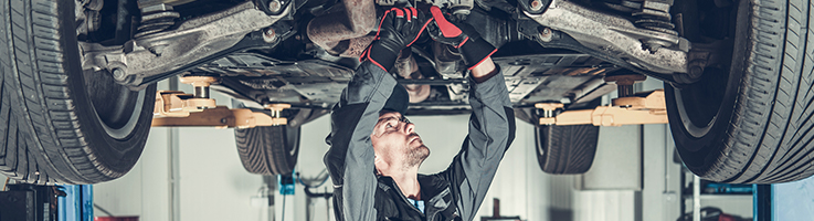 mechanic looking at car