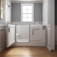 an open walk-in tub installed by a window