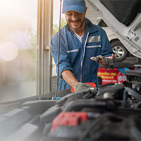 auto mechanic inspecting car engine