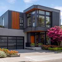 a modern two-story house with dark gray panels and vertical wooden slats