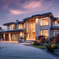 a modern two-story house shown at sunset with clean lines, large windows, and a mix of stone, glass, and metal materials