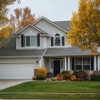 a house with a driveway and front lawn