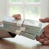 mortgage loan officer handing money to homebuyer