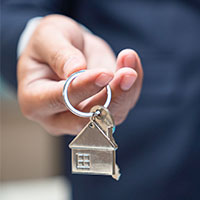 man holding a house key