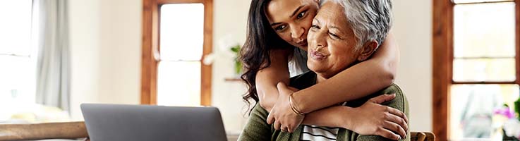 mother and daughter looking at a computer