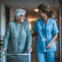nurse helping woman with walker