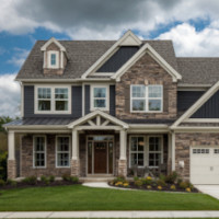 a two-storey house with a lawn in front and a garage to the side