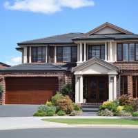 a nice home with large windows and front yard planted with pretty bushes