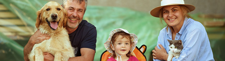 couple with young daughter and dog and cat