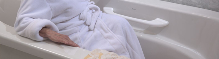 woman in bathrobe in walk in tub