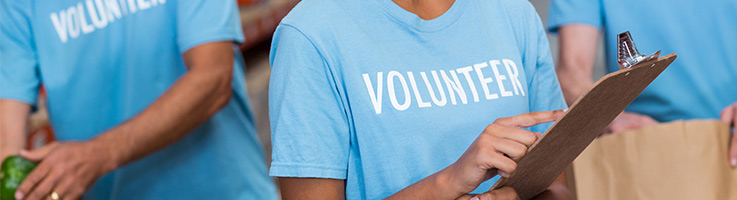three volunteers packing boxes