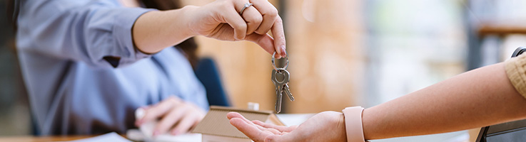 real estate agent giving keys to house