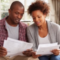 a man and a woman looking at paperwork together