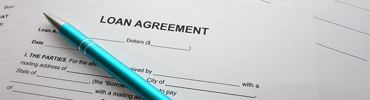 blank loan agreement form with a pen on top