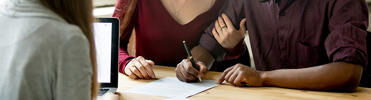 couple signing papers