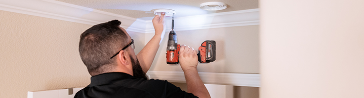 home security employee installing a security system