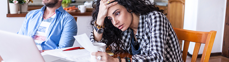 stressed woman holding papers