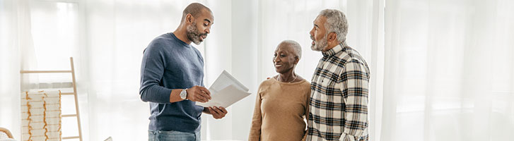 elderly couple discussing with a mortgage broker